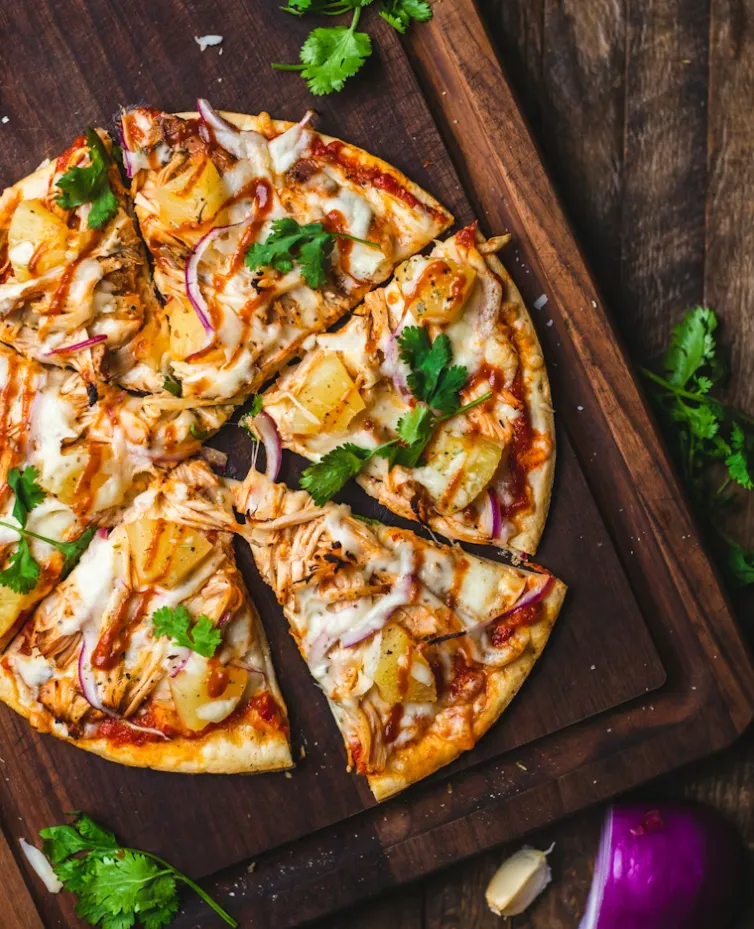Chicken pizza with pineapple, red onions and cilantro ready for takeout from Samra's Pizza in Sage Hill, Calgary